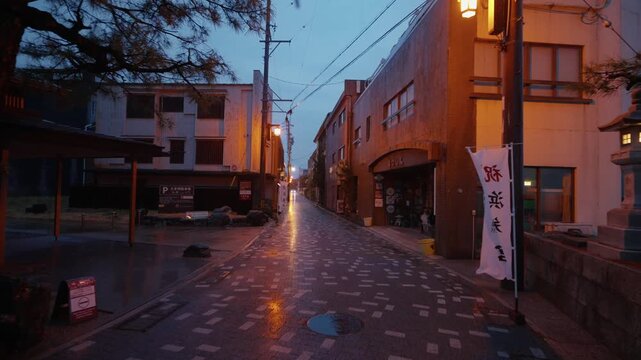 Walking in the rain on Japanese street at dawn in Ise, Mie Prefecture