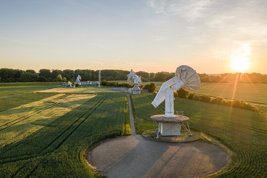 Aerial view of the Satelliten-Messstelle Leeheim satellite measuring station with large antennas in green fields during golden hour Riedstadt, Hessen, Germany.