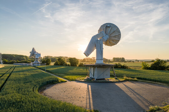Aerial view of the Satelliten-Messstelle Leeheim with large parabolic antennas standing in green fields under a golden sunset sky Riedstadt, Hessen, Germany.