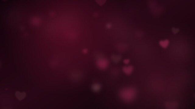 Soft heart bokeh lights gently drift on a dark red background