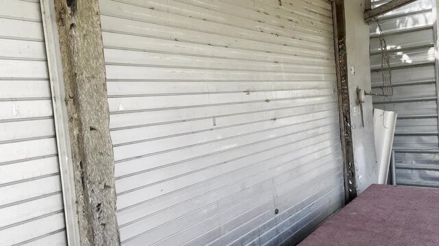 Closed metal rolling door of a traditional shop or kiosk in rural area