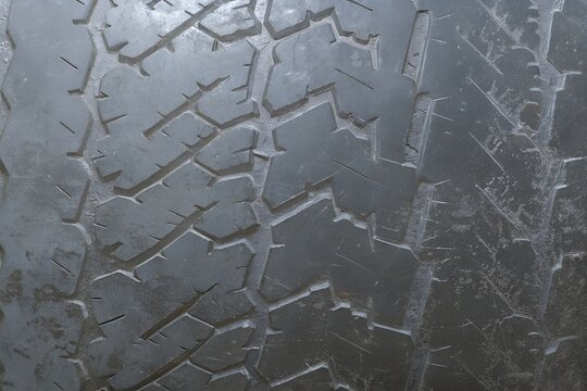 Dark charcoal rubber tire tread texture pattern background panel