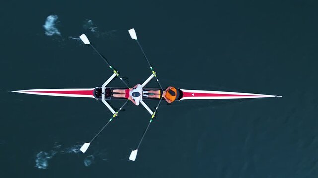 Top view,In the stunning waters of Halifax Ocean Bay, a dedicated crew of Men athletes skillfully maneuvers a sleek rowing boat, showcasing teamwork and passion for water sports