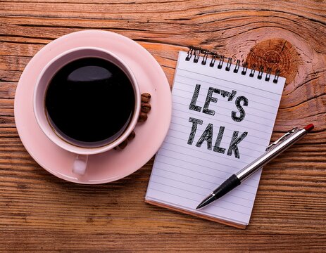 handwriting text let s talk written on notepad suggesting beginning of conversation on important topic stationery placed next to ceramic cup of black coffee above rustic wooden