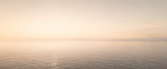 Fototapeta premium Serene Ocean Horizon: A tranquil seascape with a vast, calm ocean stretching to a soft, ethereal horizon, bathed in the gentle, warm hues of dawn or dusk.