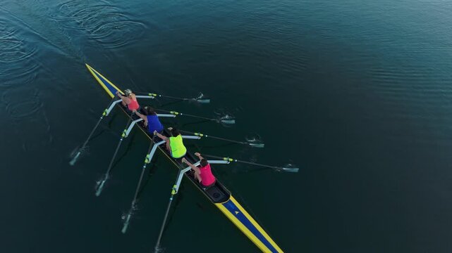 Beneath the soft glow of sunrise, four determined women rowers glide gracefully across the serene waters of Halifax Bay, showcasing strength and unity in nature