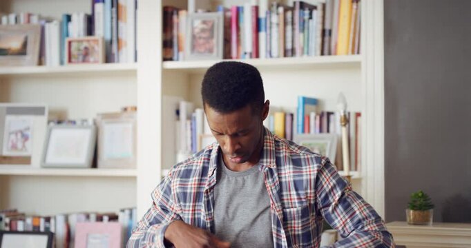 Dance, hip hop and black man in home with energy, rhythm or movement to playlist on weekend. Music, groove and African male person listening to album with choreography in living room at house.