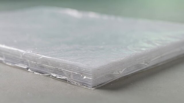 Medium framing of paper laminated with a starch blend film emphasizing biodegradable material application for environmentally responsible packaging solutions.