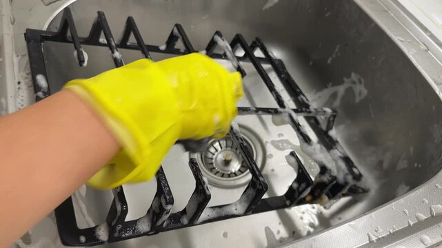 Kitchen cleaning, gloved hands washing stove grate under running water in sink, spring cleaning, home hygiene, deep cleaning and everyday household chores