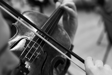 Close up of child hand playing violin during classical orchestra concert © Ruslan