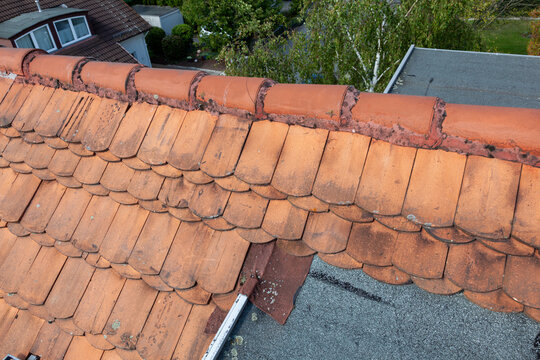 detail of damaged roof of a family house with old beaver tail