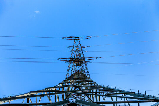 Steel electricity pylon on  blue sky