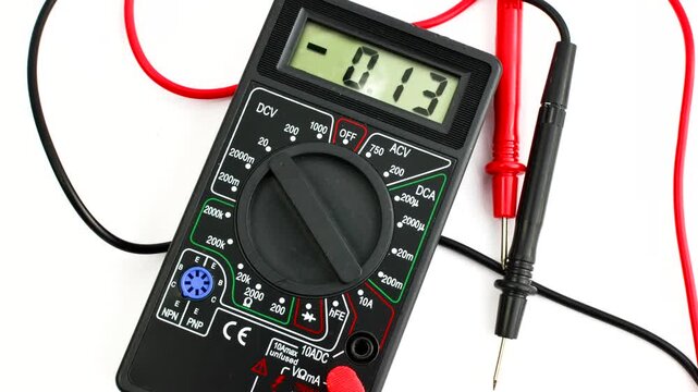 Close-up of a multimeter on a clear surface, highlighting precision and versatility for electrical measurements.