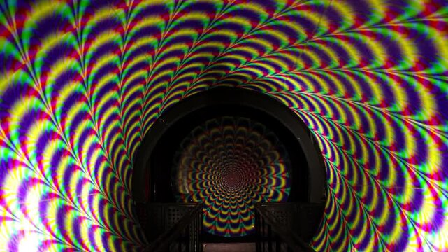 Vortex tunnel - rotating psychedelic light tunnel at a funhouse attraction, creating an optical illusion and vertigo
