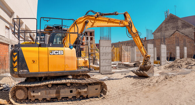 3 May 2026, Pancevo, Serbia: Yellow JCB heavy equipment excavator parked on a sandy construction site preparing ground for new building foundation