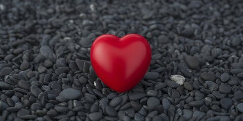 Fototapeta premium Single Glossy Red Heart Object Centered on a Textured Bed of Black Beach Pebbles
