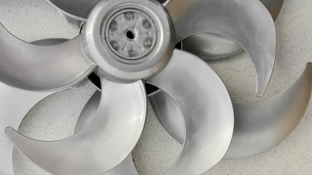 New fan impeller, disassembled into a technical composition, ready for assembly and use. Meticulous detail of newly manufactured fan impeller, disassembled for inspection and assembly.