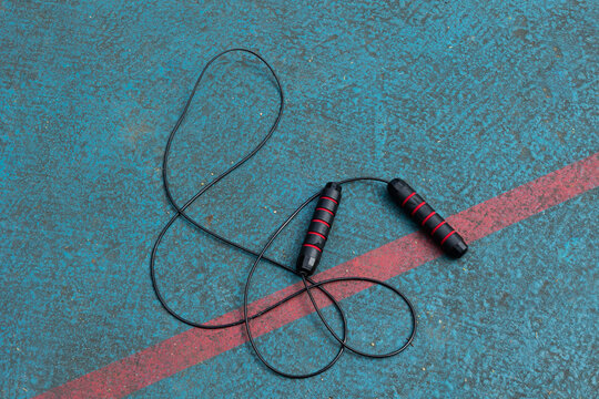 Top view of a jump rope on a sports court with copy space. Concept of training, cardio exercise, fitness, and a healthy lifestyle