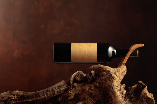 Bottle of red wine with empty paper label.