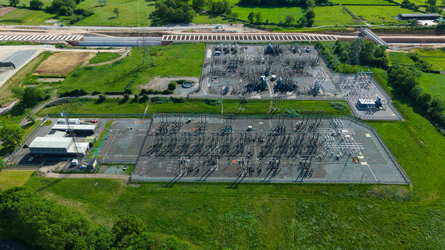 Aerial view of Berkswell Substation National Grid featuring electrical infrastructure and transformers surrounded by green fields in the countryside of Coventry, England, United Kingdom.