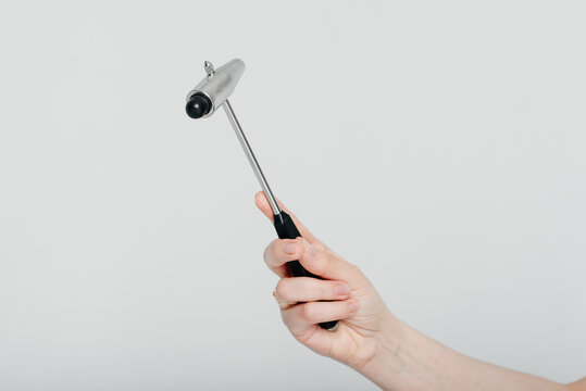 neurologist holds neurological reflex hammer for testing human reflexes in hand, medical services, tools and equipment for treatment