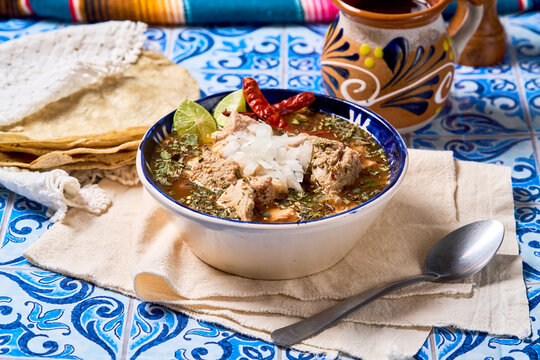 Traditional Mexican menudo soup in a rustic table