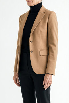 Studio portrait of woman wearing blank camel blazer mockup over black turtleneck, commercial fashion template on white background