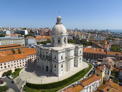 Central dome-shaped building in the foreground of a dense urban environment on a clear day, buildings, a bridge and green trees, aerial view, Igreja de Santa Engr&aacute;cia, Pante&atilde;o Nacional, Santa Engracia, National Pantheon, Lisbon, Lisboa, Portugal