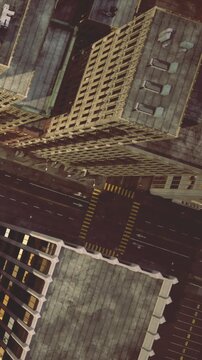 Tall buildings rise high above the streets in the city. Roads wind through the urban landscape, creating a network of connections. The scene captures the busy atmosphere of city life.