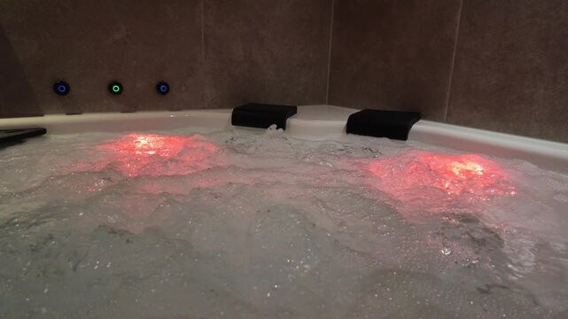 Sparkling water splashes in jacuzzi, pool in golden sunset light, glowing droplets rising 
