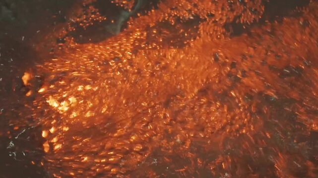 Sparkling water splashes in jacuzzi, pool in golden sunset light, glowing droplets rising 