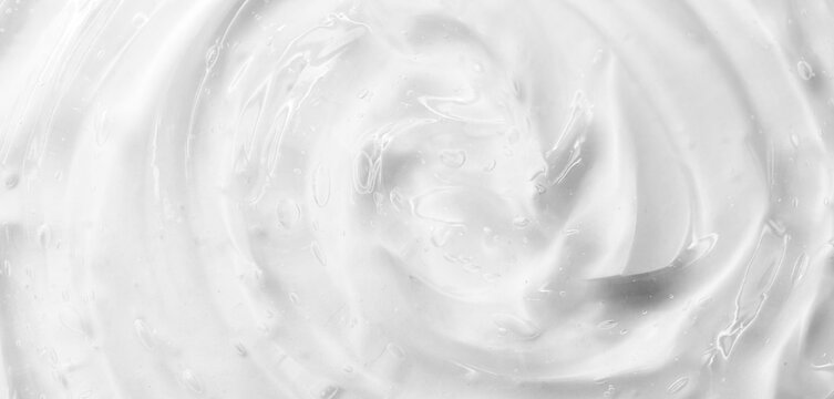 Cosmetic gel, serum transparent sample. Liquid cream with bubble texture. Gel texture of a cosmetic product. Clear liquid lotion for skin care.