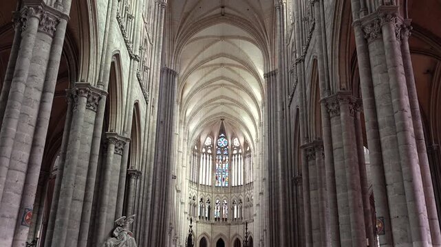 Interior of Amiens Cathedral with vaulted nave stained glass and gothic columns