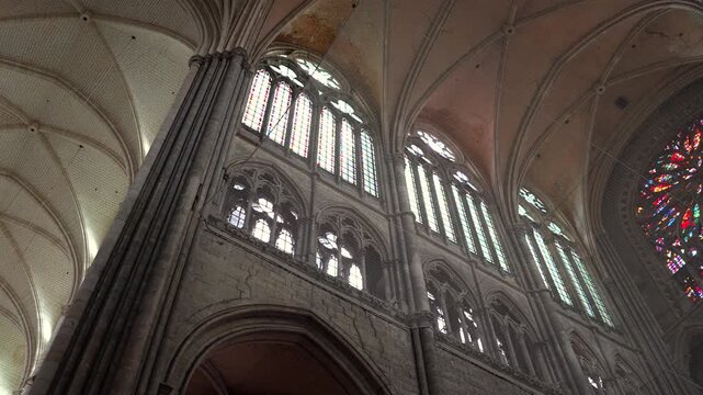 Interior of Amiens Cathedral with high vaulted ceiling and tall gothic windows