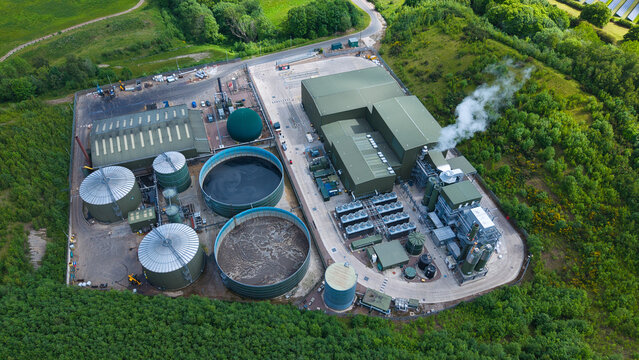 Aerial view of the Biogen Atherstone anaerobic digestion plant with industrial tanks and processing buildings surrounded by lush green trees Atherstone, England, United Kingdom.