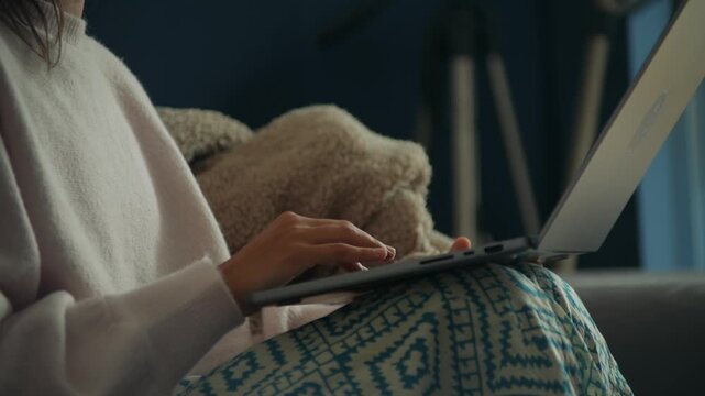 Home editor composing on laptop near tripod, calm workflow