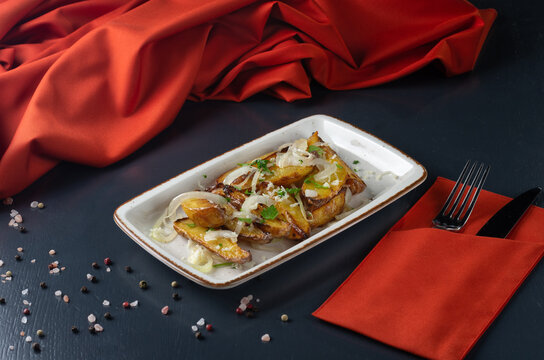 Baked potato wedge with herbs. Vegan potato wedge baked snack food meal. Golden rustic country baked potato wedge fries
