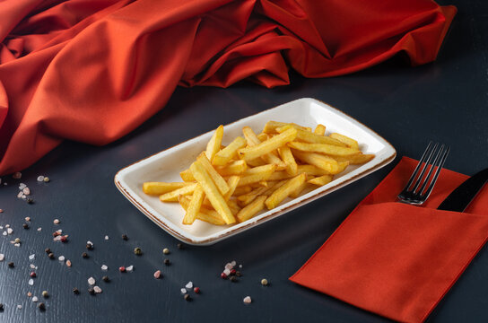 French fries in a bowl On a dark background. Menu for a Georgian restaurant