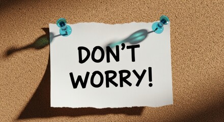 Obraz premium Don't Worry Note Pinned to Corkboard with Blue Push Pins and Strong Graphic Shadows