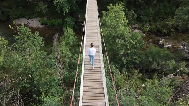 Suspension bridge connecting forest banks over the lerez river in galicia, spain