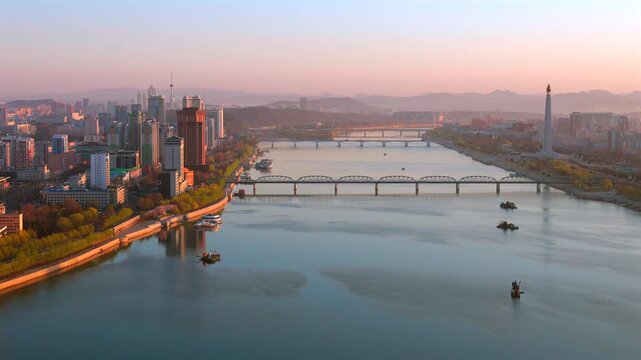 Juche Tower, Pyongyang morning panoramic view, North Korea. Taedong River in the morning fog. View facing upstream, modern residential complex. View from Yanggakdo Hotel
