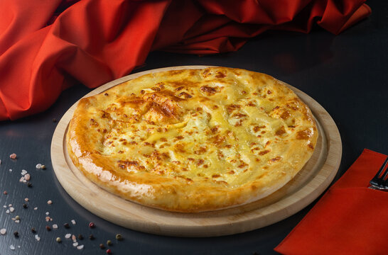 khachapuri with cheese, megrelian khachapuri, georgian cuisine on wooden table