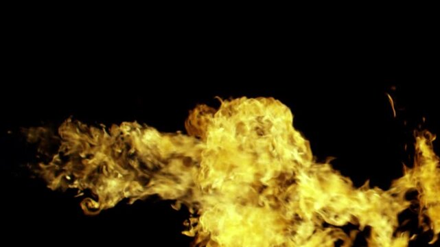 Intense stream of fire and flames moving horizontally on an isolated black background.