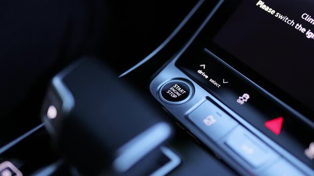 Pressing Stand By Power Button To Turn On and Off the Hybrid Car. Pushing start stop Button to start keyless ignition hybrid car electro engine. Starting car engine. Button to start the car engine.