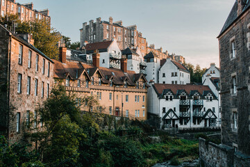 Obraz premium Picturesque historic stone houses of Dean Village by the Water of Leith, Edinburgh, Scotland