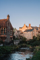 Fototapeta premium Picturesque historic stone houses of Dean Village by the Water of Leith, Edinburgh, Scotland
