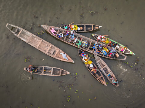 Aerial view of traditional wooden boats and people at the floating market in Ganvie, Atlantique, Benin.