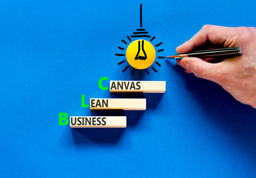 BLC business lean canvas symbol. Concept words BLC business lean canvas on beautiful wooden blocks. Beautiful blue background. Businessman hand. BLC business lean canvas concept. Copy space.