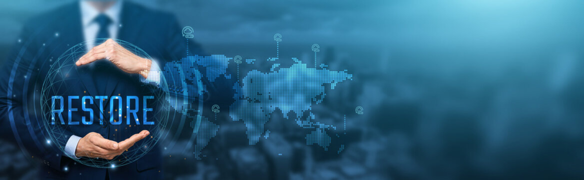 Businessman holding a virtual sphere with "RESTORE" text and a global map, representing data recovery, system restoration, and global solutions.