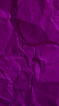 Vertical stop-motion animation of dark pink wrinkled paper. Seamless loop for cool-toned mobile backgrounds and professional vertical content.